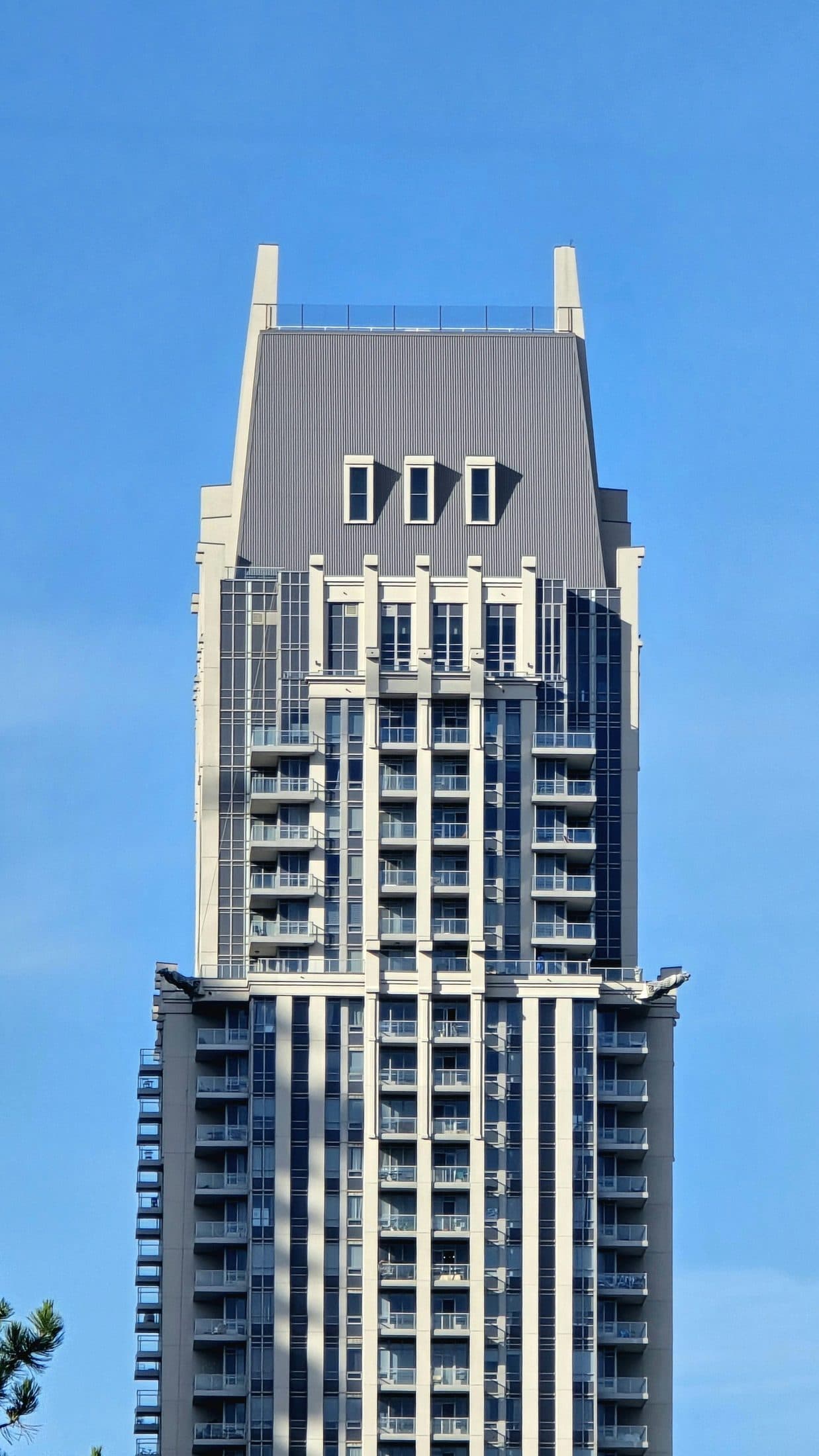 Demo image. Tall residential tower against a clear sky.